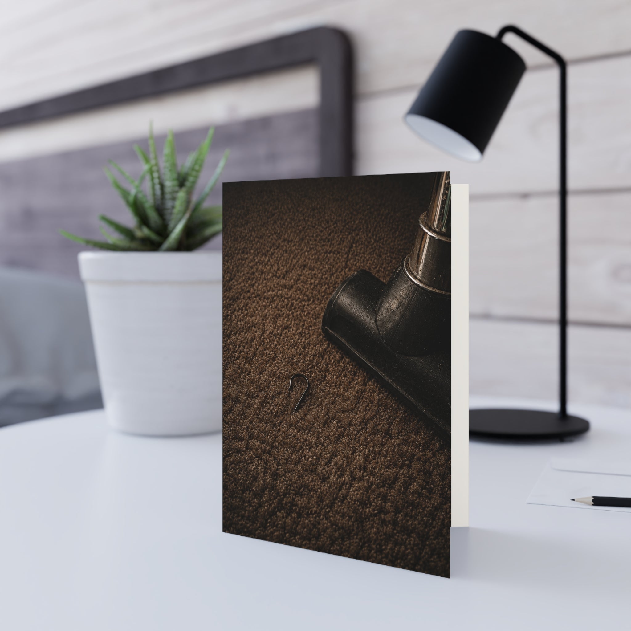 Found / You thought Christmas was gone. Then the vacuum stopped. A single ornament hook. Too small to notice for weeks. Big enough to bring the whole season back. / Holiday Greeting Card