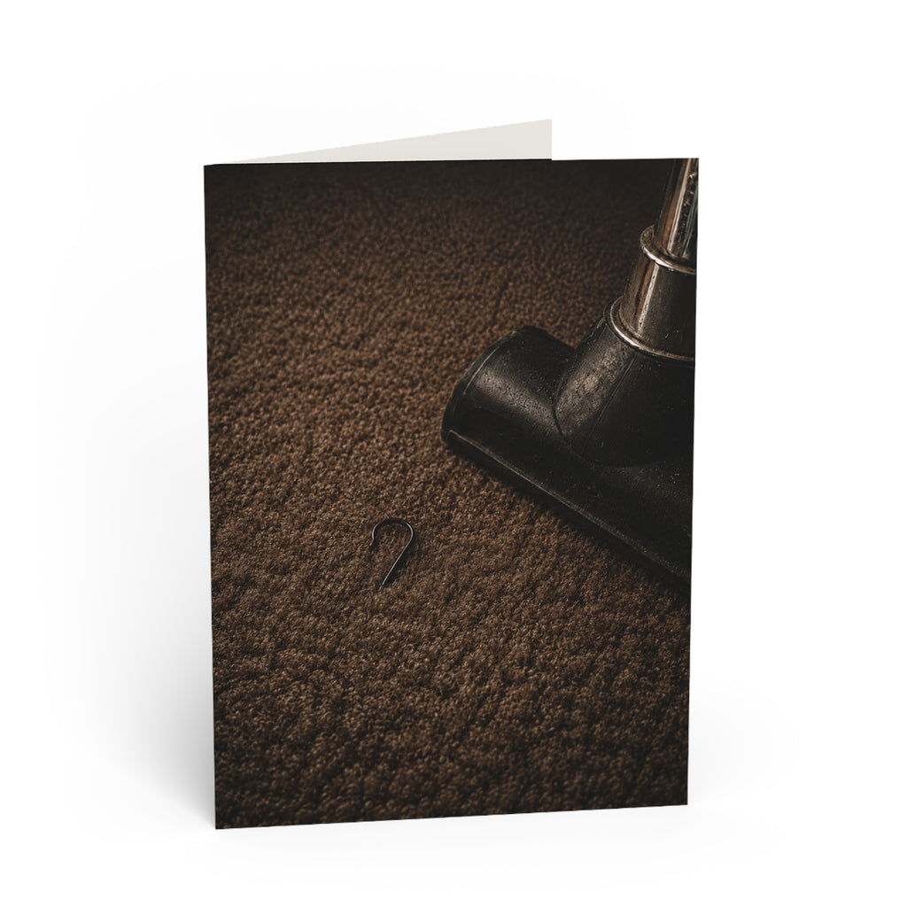 Found / You thought Christmas was gone. Then the vacuum stopped. A single ornament hook. Too small to notice for weeks. Big enough to bring the whole season back. / Holiday Greeting Card