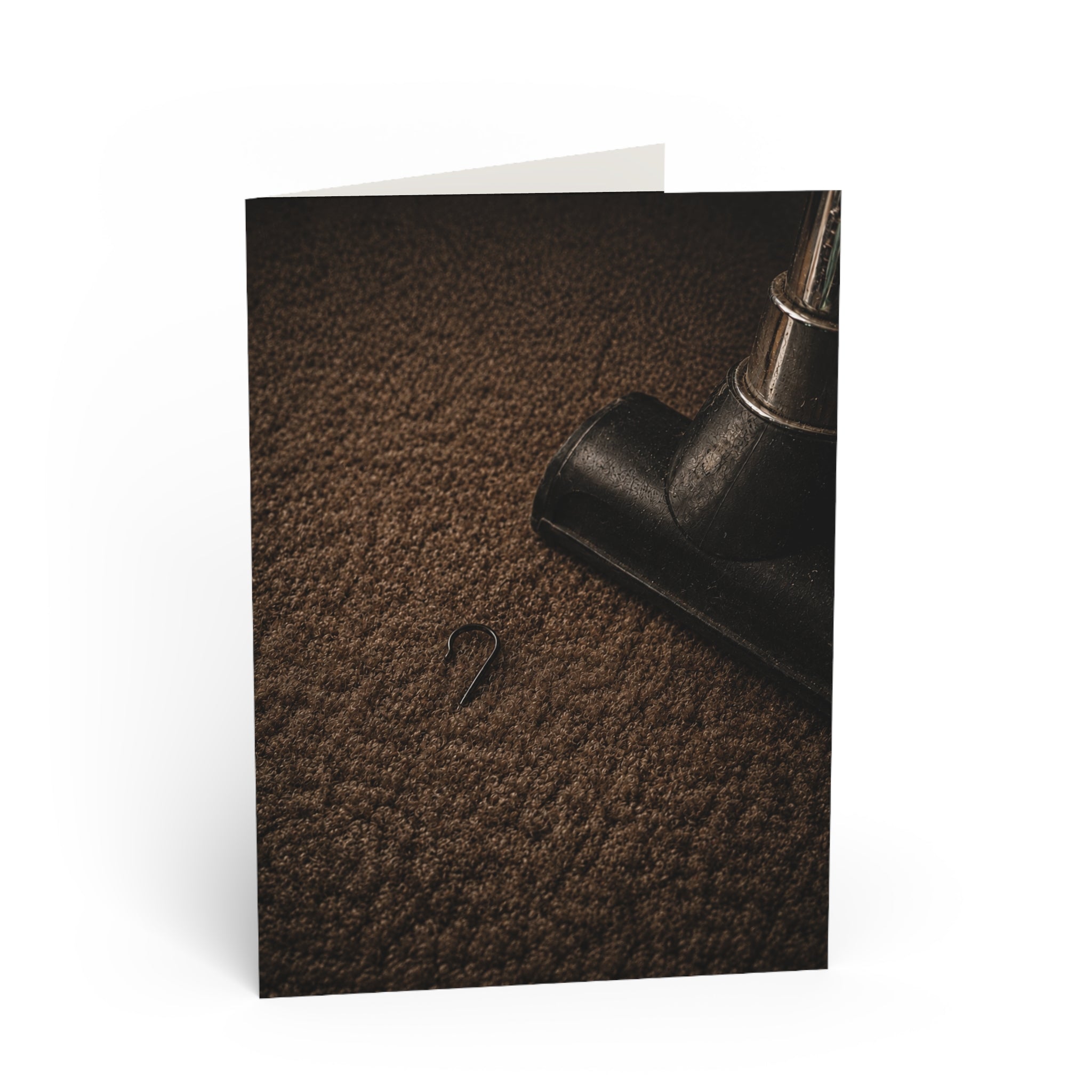 Found / You thought Christmas was gone. Then the vacuum stopped. A single ornament hook. Too small to notice for weeks. Big enough to bring the whole season back. / Holiday Greeting Card